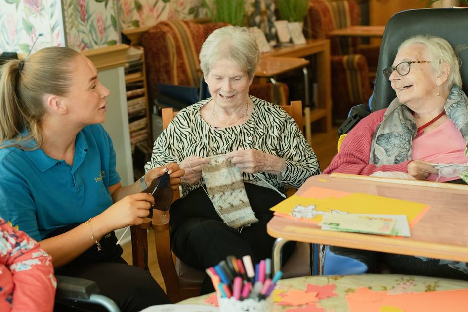 Diverse team of senior care advisors reviewing documents in a cozy, well-lit office space